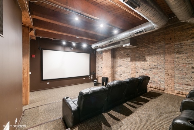 1040 West Adams Street, Unit 610 Chicago, IL 60607 - Photo 18 of 24 a projector room with fireplace furniture