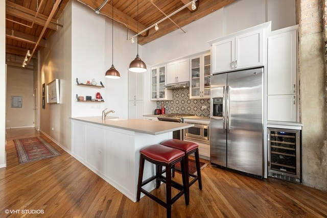 1040 West Adams Street, Unit 610 Chicago, IL 60607 - Photo 5 of 24 a kitchen with stainless steel appliances a refrigerator and a stove top oven
