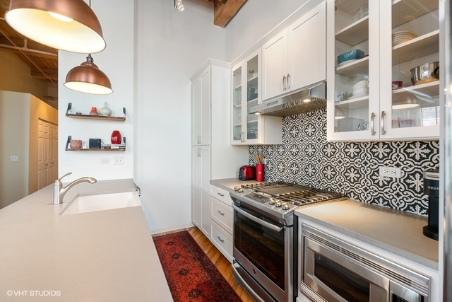 1040 West Adams Street, Unit 610 Chicago, IL 60607 - Photo 6 of 24 a kitchen that has a sink and a stove