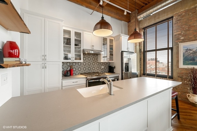1040 West Adams Street, Unit 610 Chicago, IL 60607 - Photo 7 of 24 a kitchen with stainless steel appliances granite countertop a sink and a refrigerator