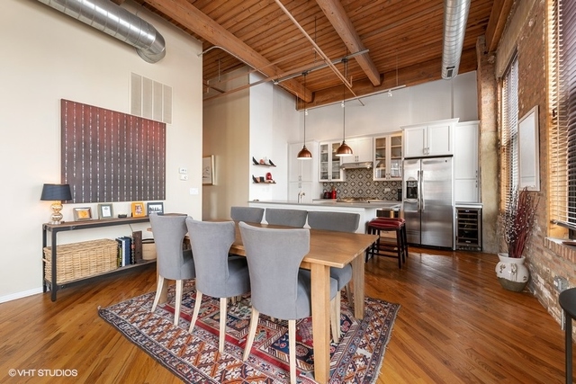 1040 West Adams Street, Unit 610 Chicago, IL 60607 - Photo 8 of 24 a dining room with furniture a rug and wooden floor