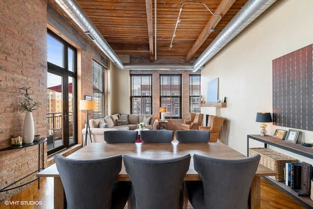 1040 West Adams Street, Unit 610 Chicago, IL 60607 - Photo 10 of 24 a dining room with furniture a large window and a rug