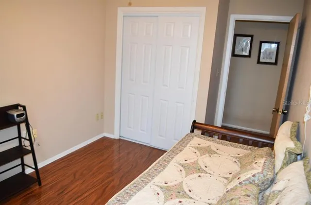 a view of a room with wooden floor and closet