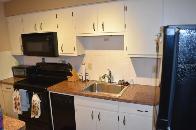 a kitchen with a sink and a stove