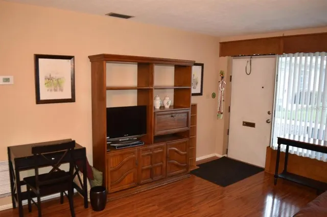 a living room with wooden floor and furniture