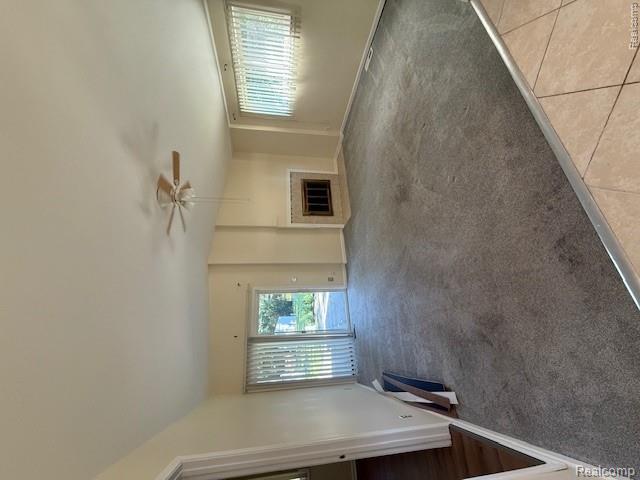 43038 Hanford Road Canton, MI 48187 - Photo 20 of 36 Spacious living area featuring a fireplace with a tiled surround, a ceiling fan, and grey carpeting
