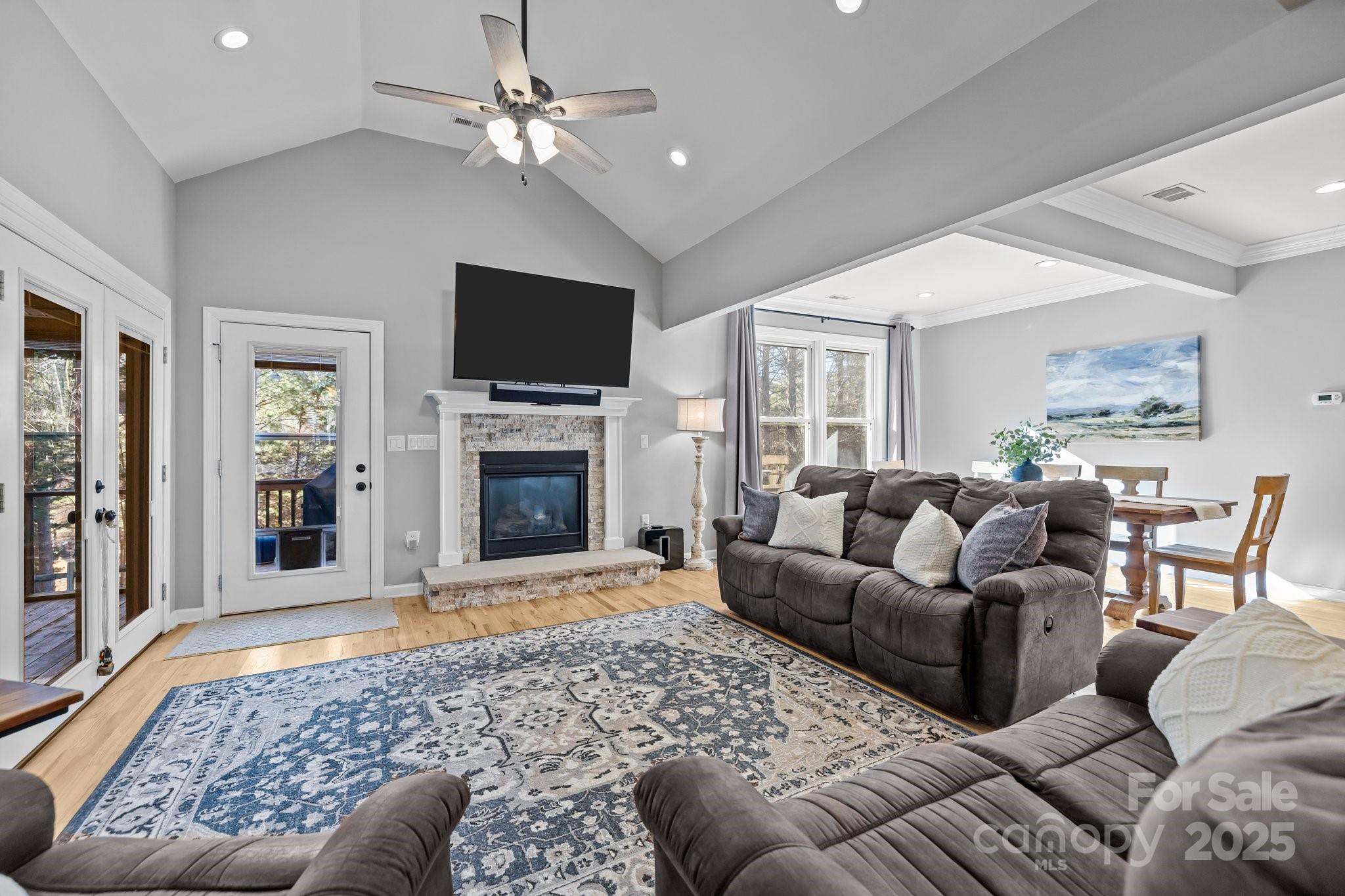 3065 River Bend Drive Tega Cay, SC 29708 - Photo 8 of 29 a living room with furniture a fireplace and a flat screen tv