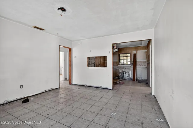 a view of a livingroom with an empty space and a window