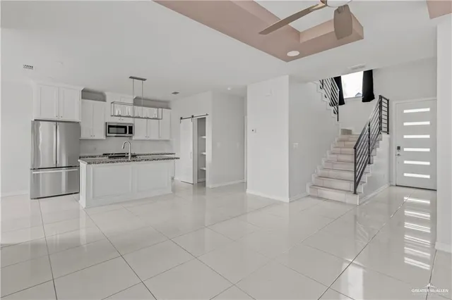 a kitchen with stainless steel appliances cabinets a sink and a counter top space