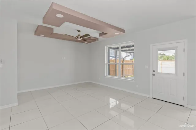 a view of empty room with windows and fan