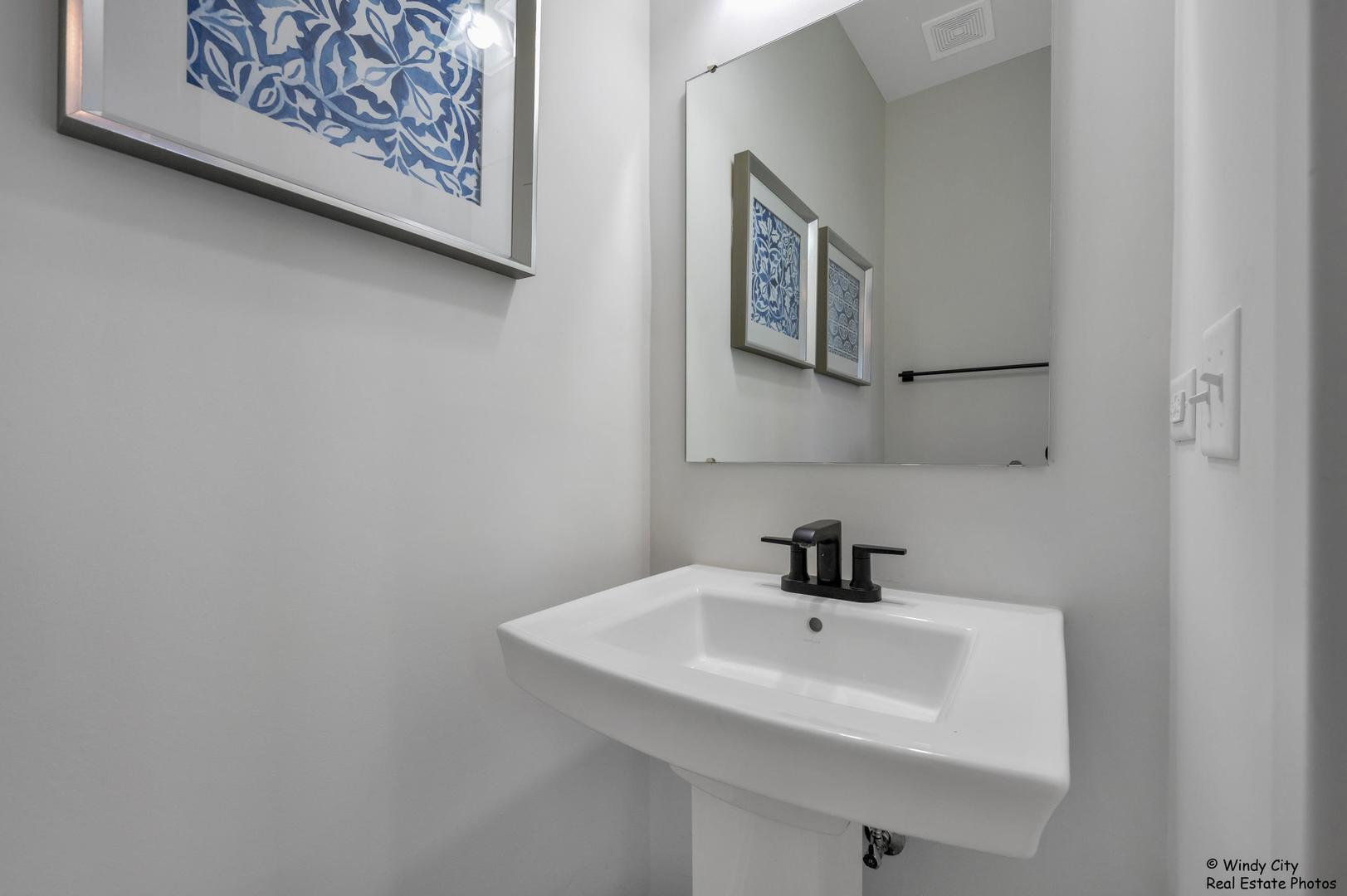 908 Jenkins Court Wheeling, IL 60090 - Photo 12 of 20 a bathroom with a sink and a mirror