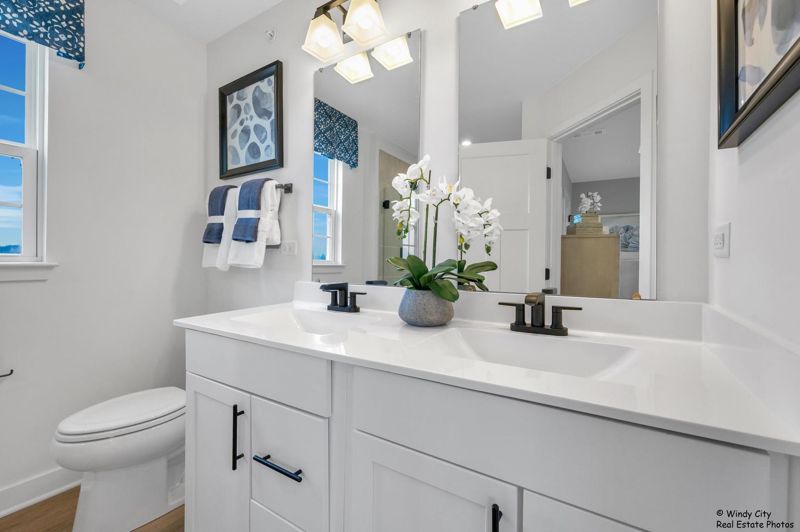 908 Jenkins Court Wheeling, IL 60090 - Photo 16 of 20 a bathroom with a sink a toilet and a mirror