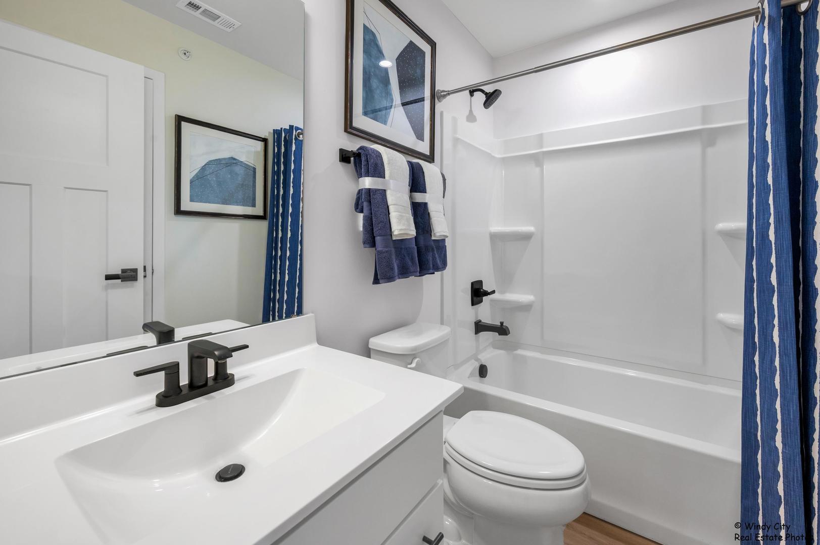 908 Jenkins Court Wheeling, IL 60090 - Photo 20 of 20 a bathroom with a sink a toilet and a bathtub