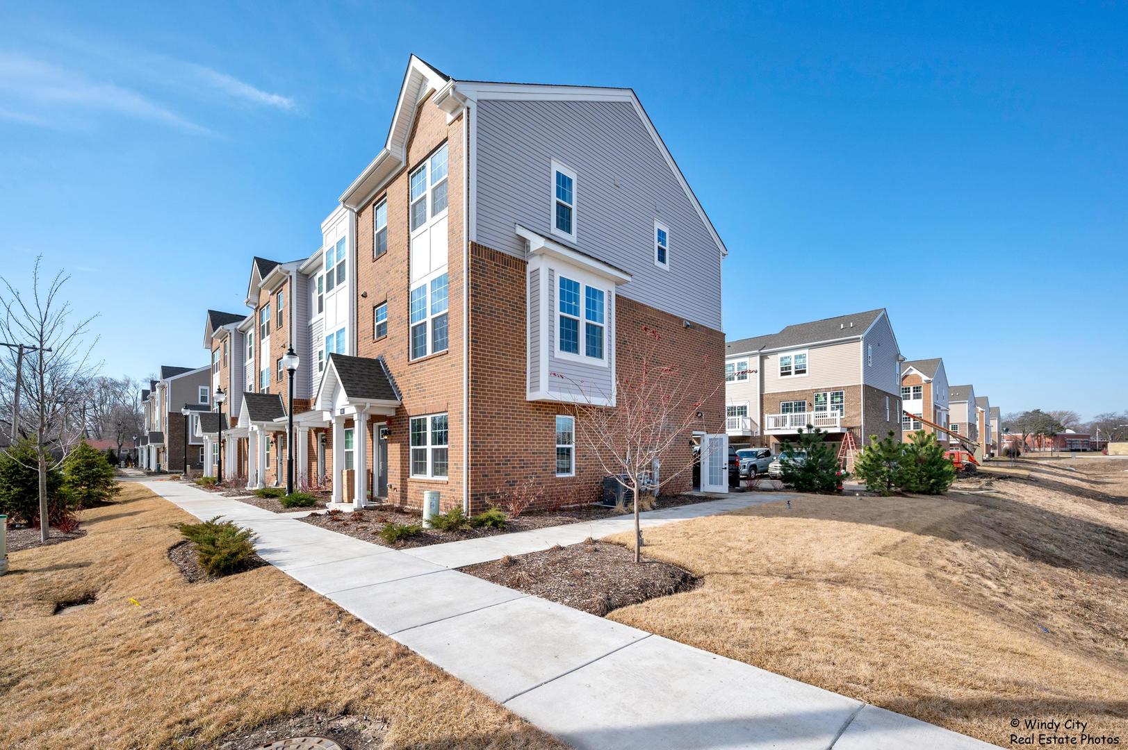 908 Jenkins Court Wheeling, IL 60090 - Photo 2 of 20 a front view of a building with street view