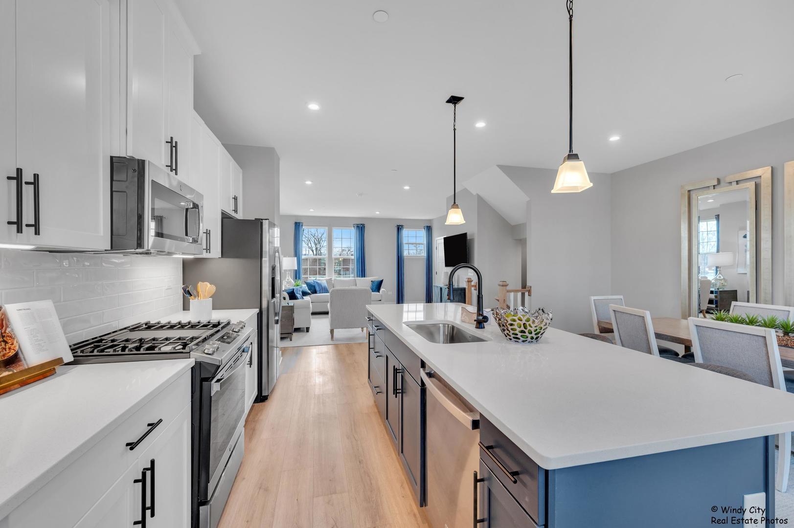 908 Jenkins Court Wheeling, IL 60090 - Photo 3 of 20 a kitchen with counter top space a sink stainless steel appliances and cabinets