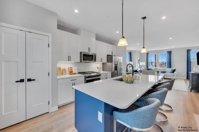 a kitchen with a sink a counter top space appliances and cabinets