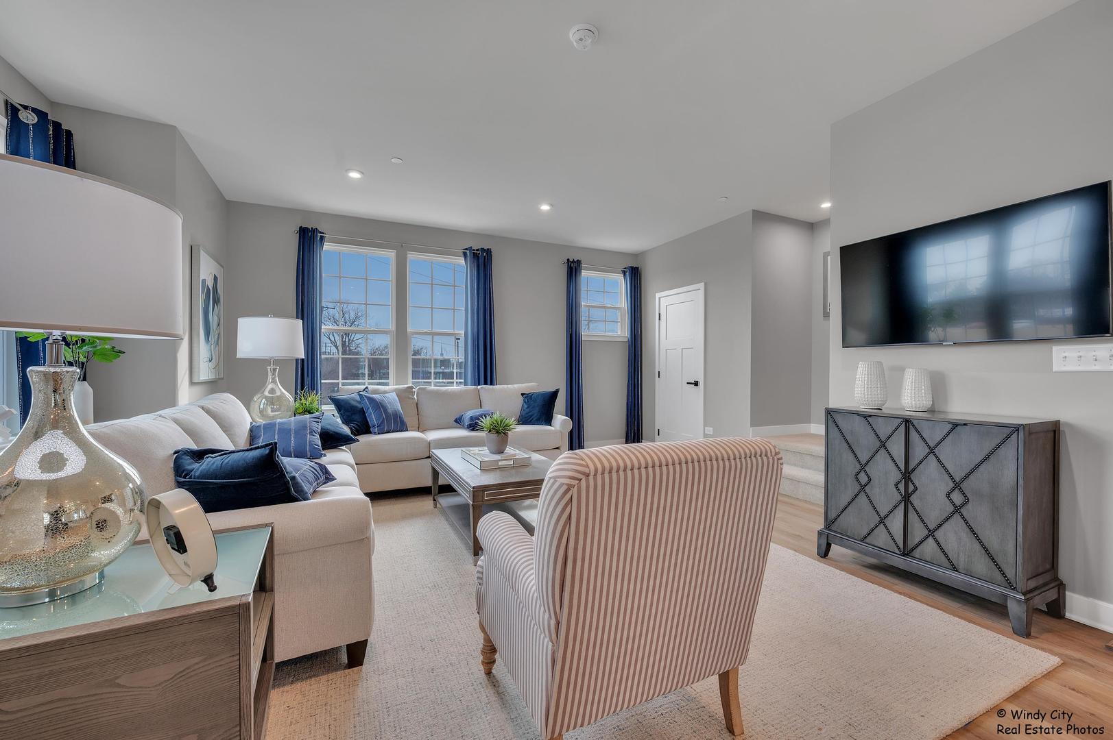 908 Jenkins Court Wheeling, IL 60090 - Photo 8 of 20 a living room with furniture and a flat screen tv