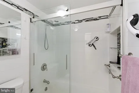 a bathroom with a shower a bath tub and shower