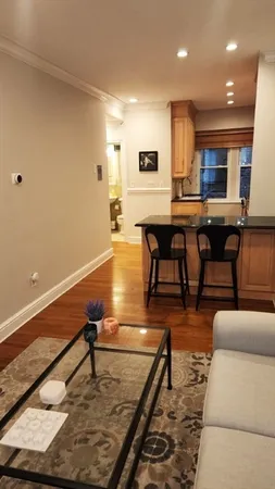 a kitchen with stainless steel appliances wooden cabinets and a refrigerator