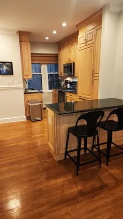 a view of kitchen with furniture and wooden floor
