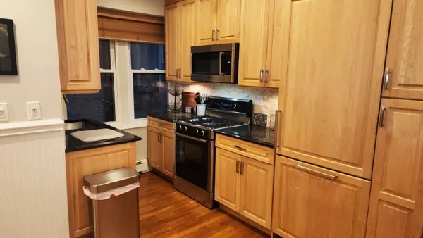 a stove top oven sitting inside of a kitchen