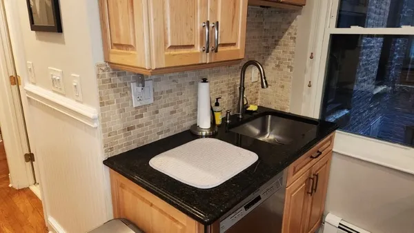 a sink sitting inside of a kitchen