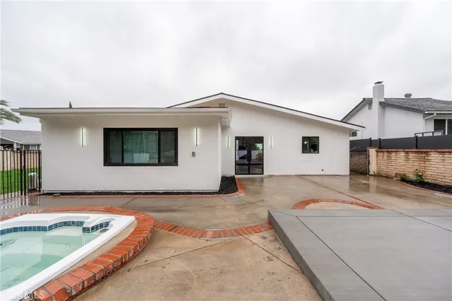 a view of a house with pool and a yard