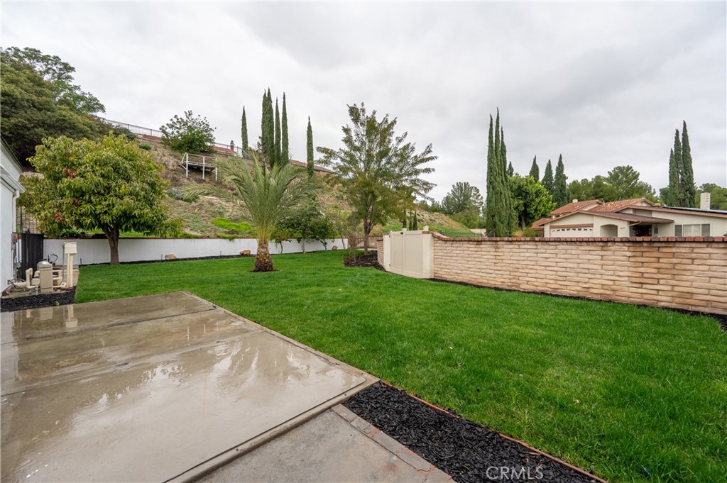 18511 Dylan Street Porter Ranch, CA 91326 - Photo 20 of 22 a view of a backyard with a garden and plants