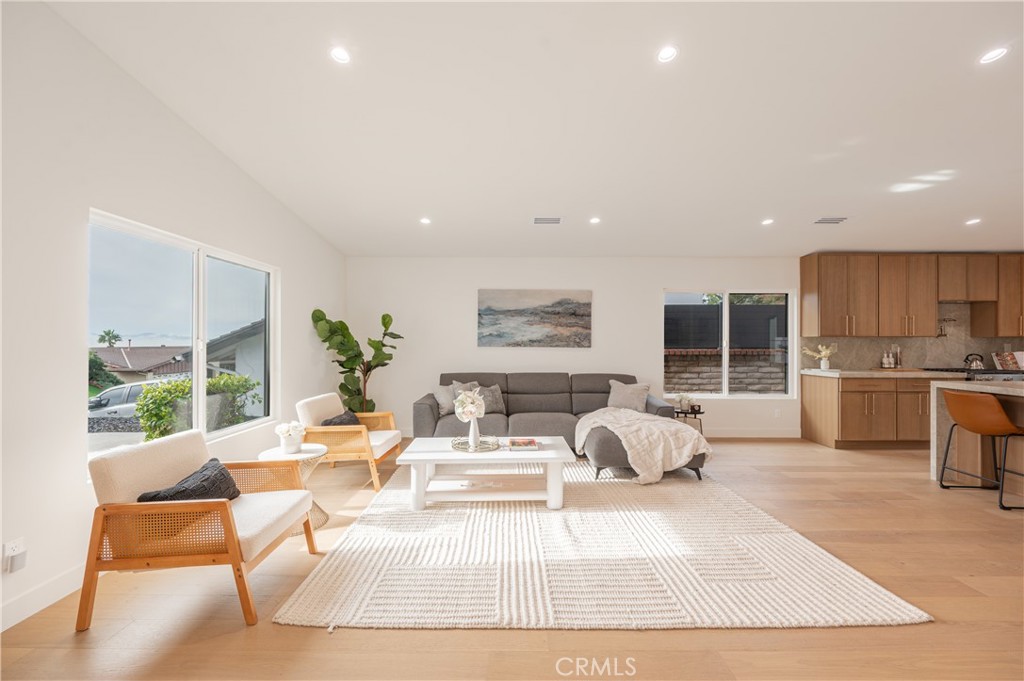 18511 Dylan Street Porter Ranch, CA 91326 - Photo 3 of 22 a living room with kitchen island furniture and a large window