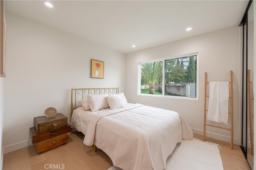 18511 Dylan Street Porter Ranch, CA 91326 - Photo 9 of 22 a bedroom with a bed and a painting on the wall