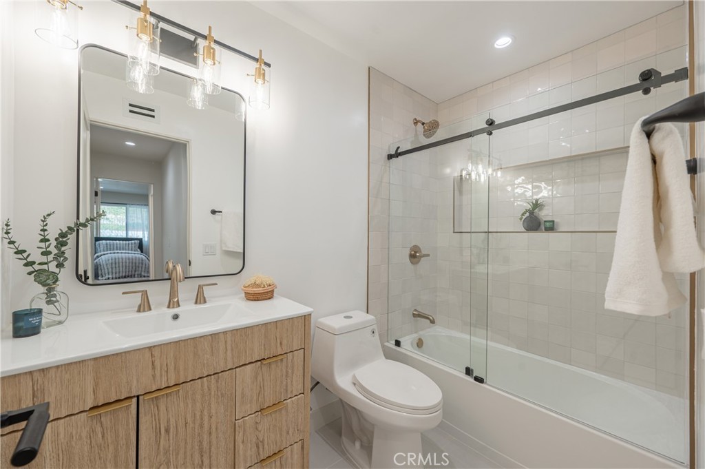 18511 Dylan Street Porter Ranch, CA 91326 - Photo 10 of 22 a bathroom with a sink double vanity mirror and a shower