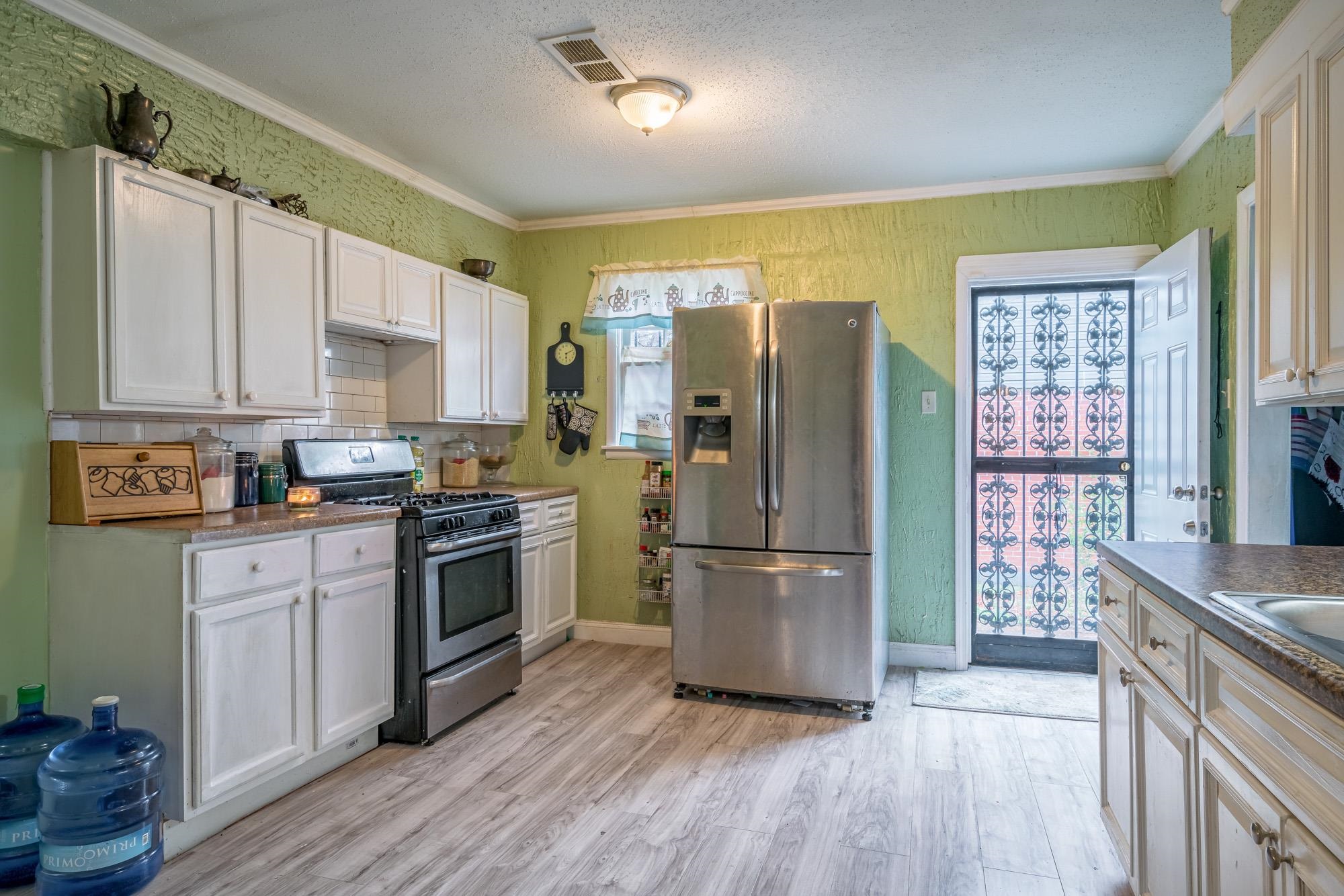 2941 North Radford Road Memphis, TN 38114 - Photo 13 of 25 a kitchen with a refrigerator cabinets and wooden floor