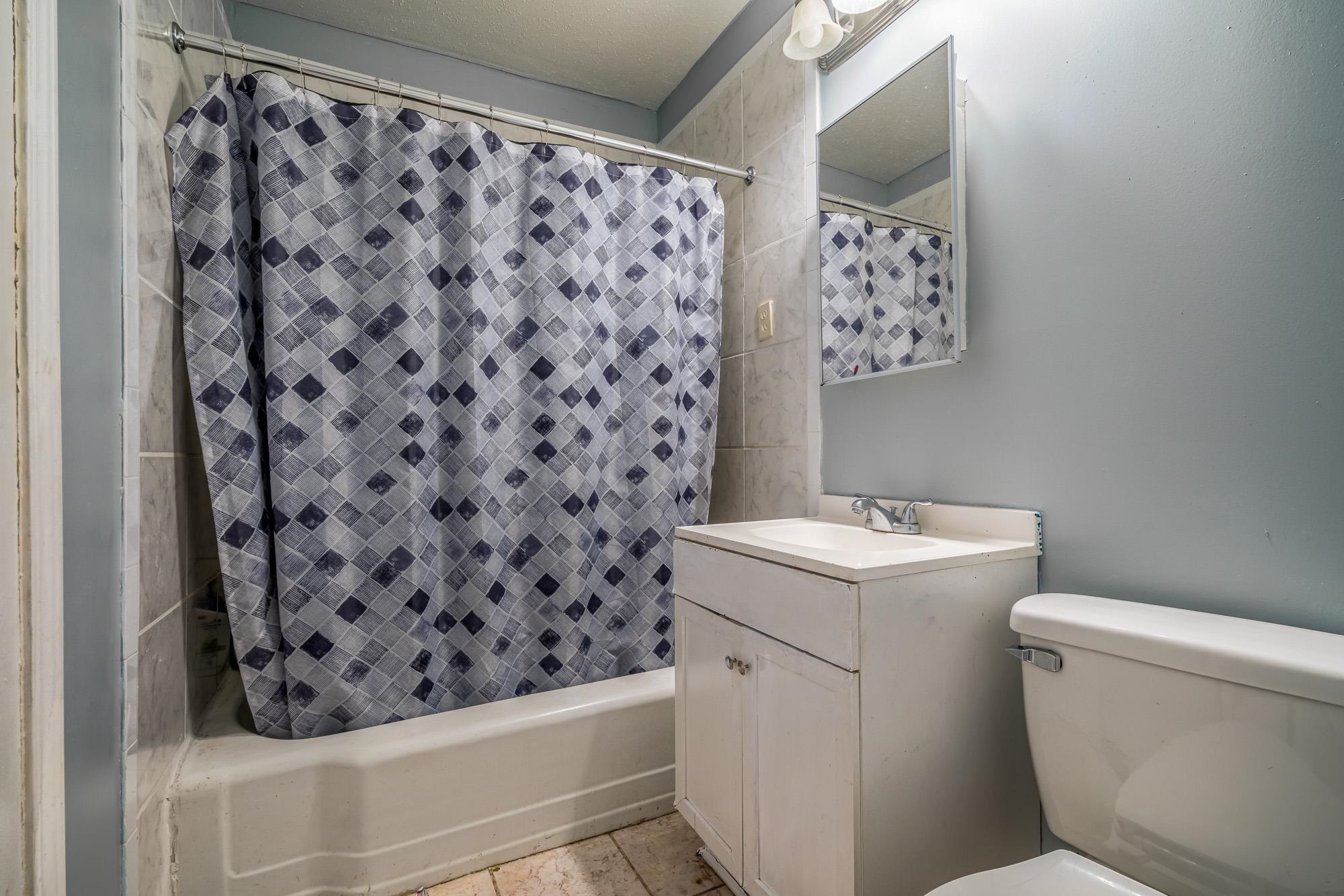 2941 North Radford Road Memphis, TN 38114 - Photo 16 of 25 a bathroom with a sink toilet and shower