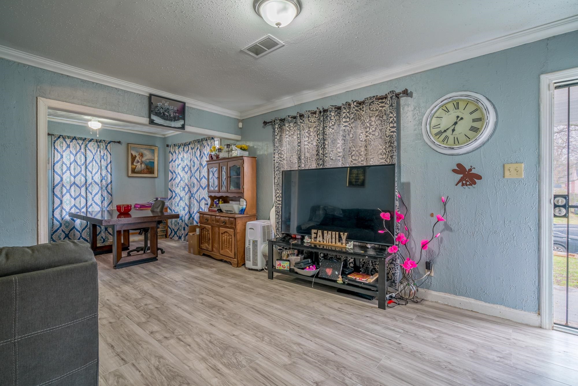 2941 North Radford Road Memphis, TN 38114 - Photo 5 of 25 a view of a livingroom with furniture and a flat screen tv