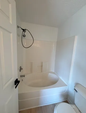 a bathroom with a sink and mirror with toilet