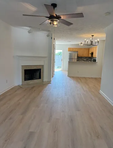 a view of an empty room with a fireplace