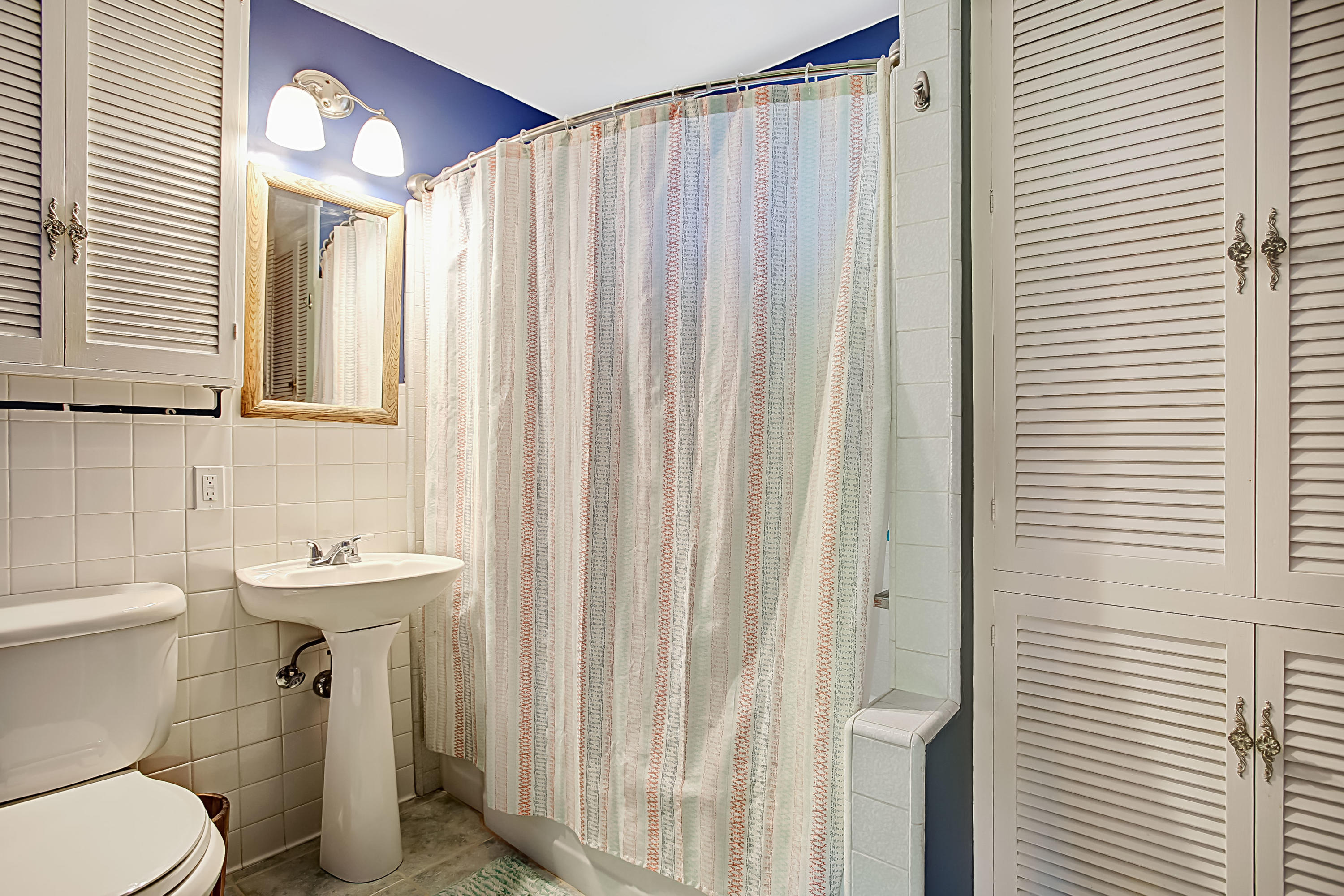3041 Foothill Road Santa Barbara, CA 93105 - Photo 13 of 25 a bathroom with a sink a toilet and shower curtain