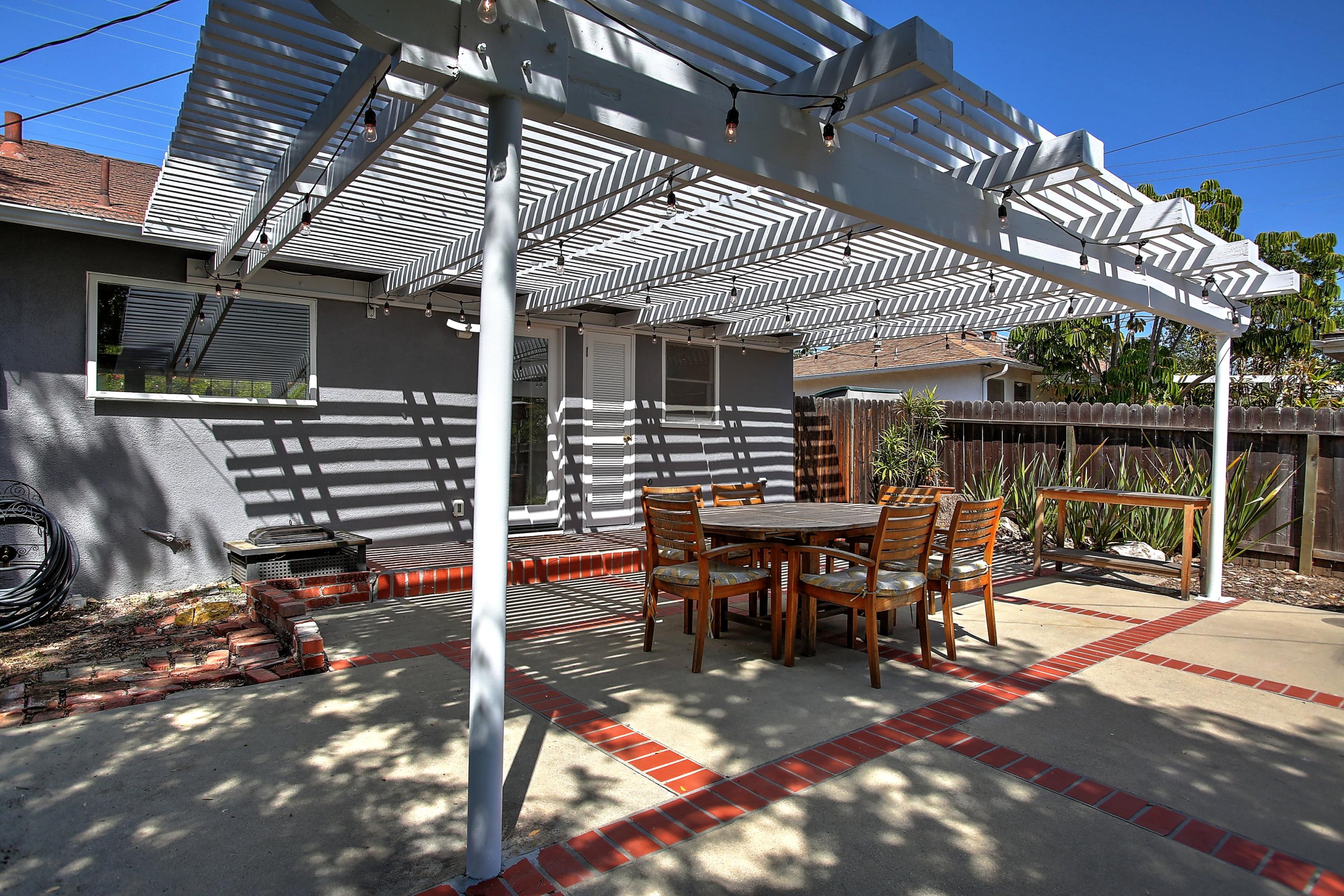 3041 Foothill Road Santa Barbara, CA 93105 - Photo 18 of 25 a view of a patio with table and chairs with wooden floor and fence