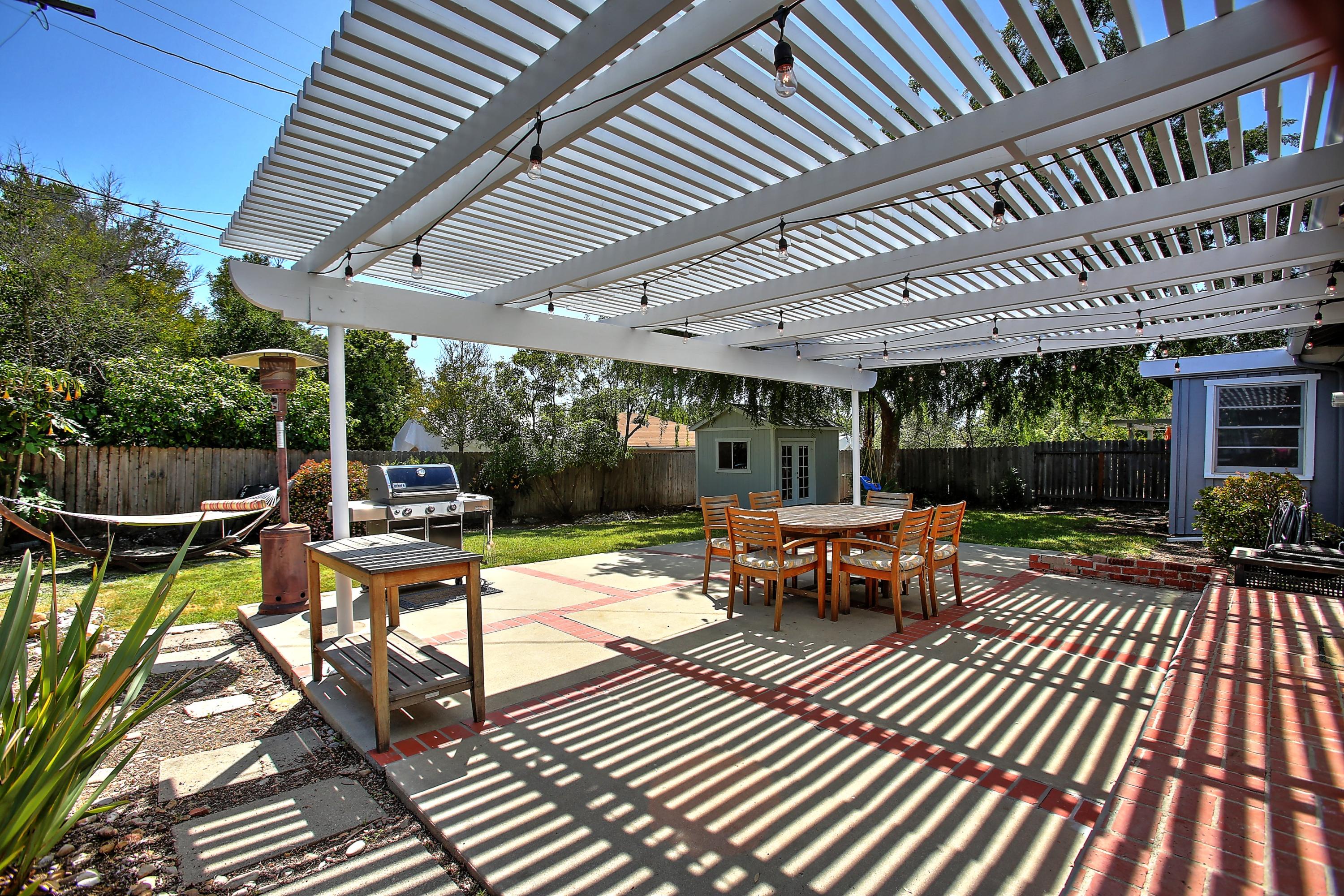 3041 Foothill Road Santa Barbara, CA 93105 - Photo 19 of 25 a view of a patio with table and chairs barbeque potted plants and large tree