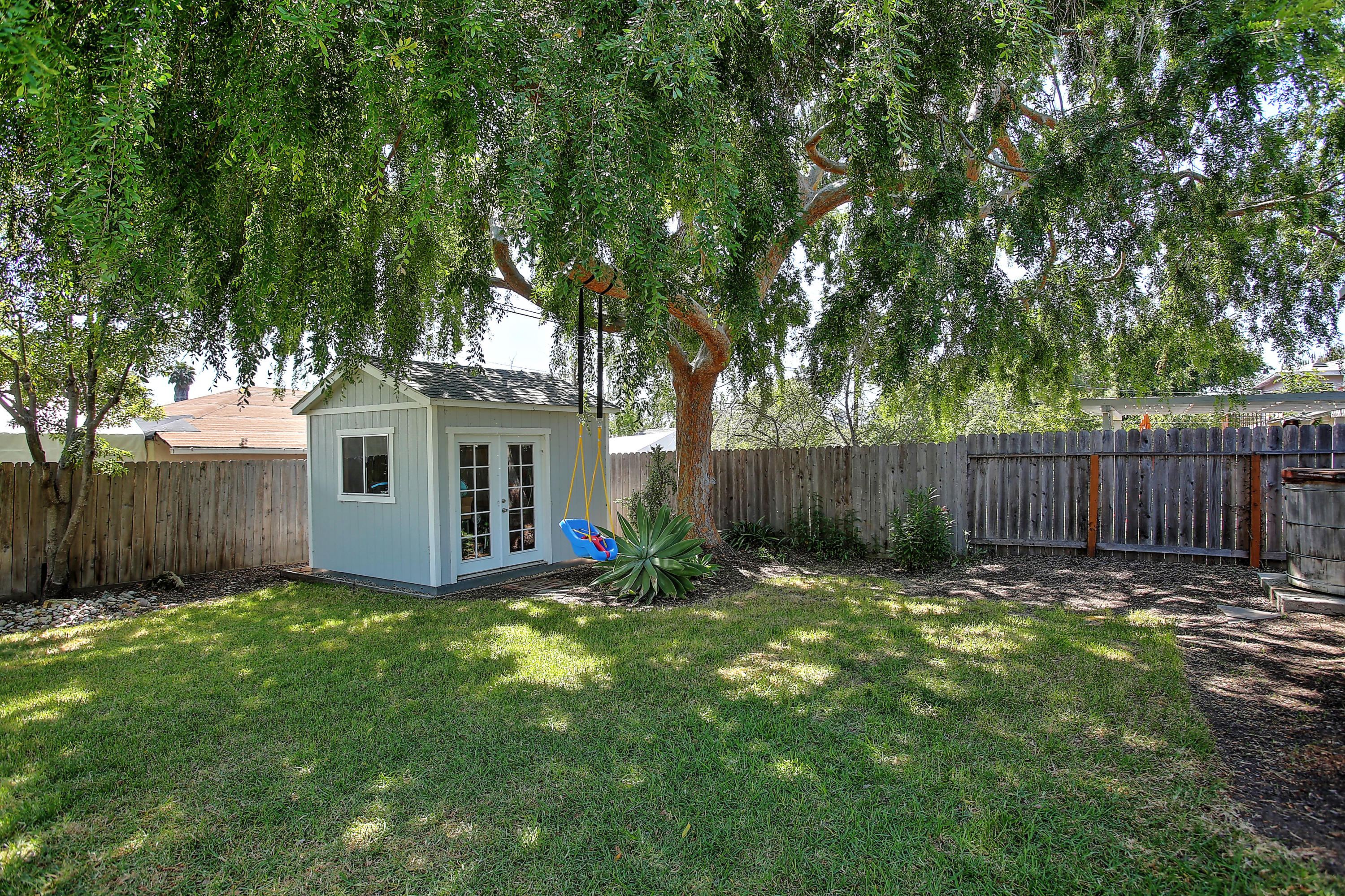 3041 Foothill Road Santa Barbara, CA 93105 - Photo 25 of 25 a view of a backyard with large trees and wooden fence