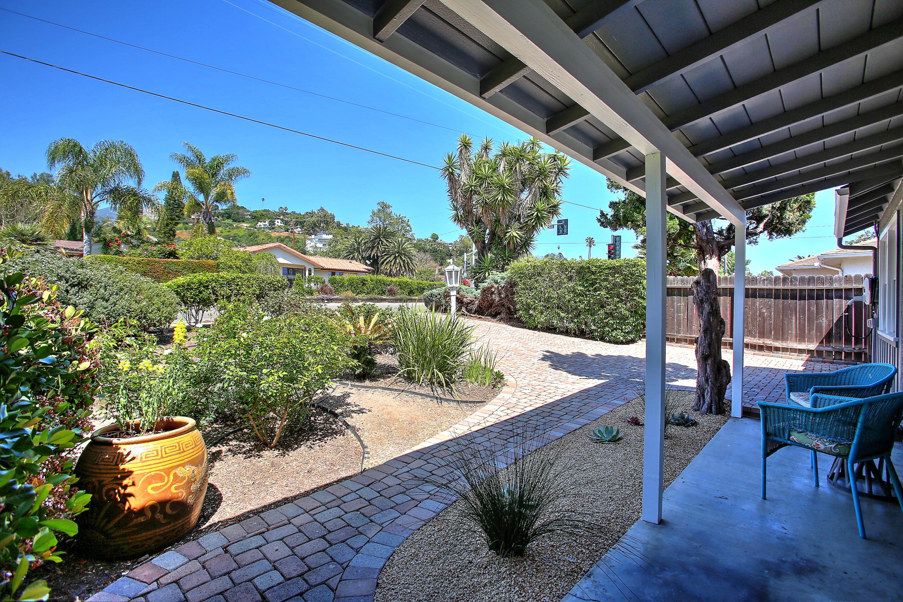 3041 Foothill Road Santa Barbara, CA 93105 - Photo 6 of 25 a view of a backyard with table and chairs potted plants with wooden floor