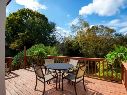 a view of a two chairs and table in the balcony