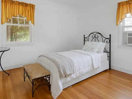 a bedroom with a bed and window