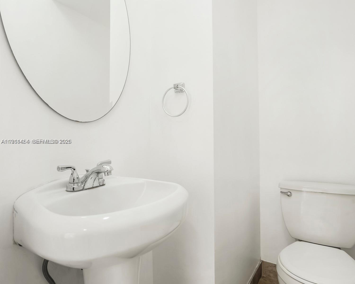 5629 Southwest 7th Street Miami, FL 33144 - Photo 11 of 25 a bathroom with a sink a toilet and a mirror