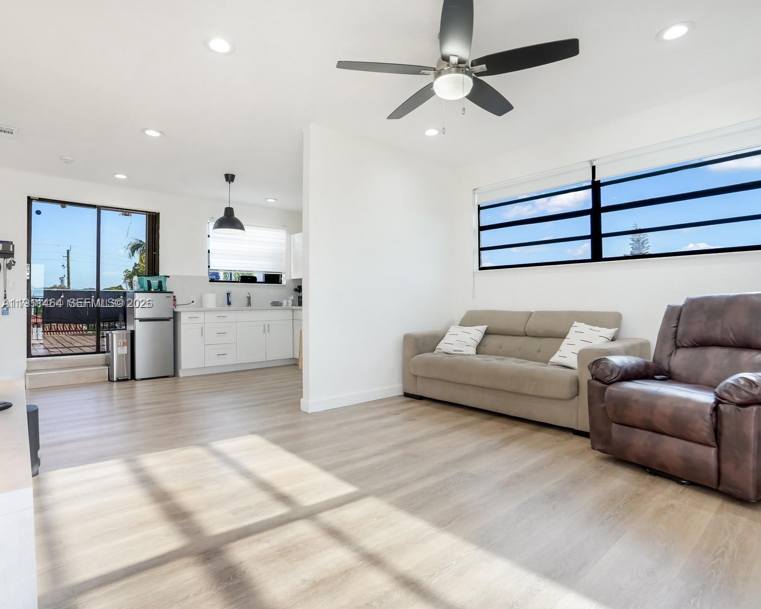 5629 Southwest 7th Street Miami, FL 33144 - Photo 21 of 25 a living room with furniture and kitchen view