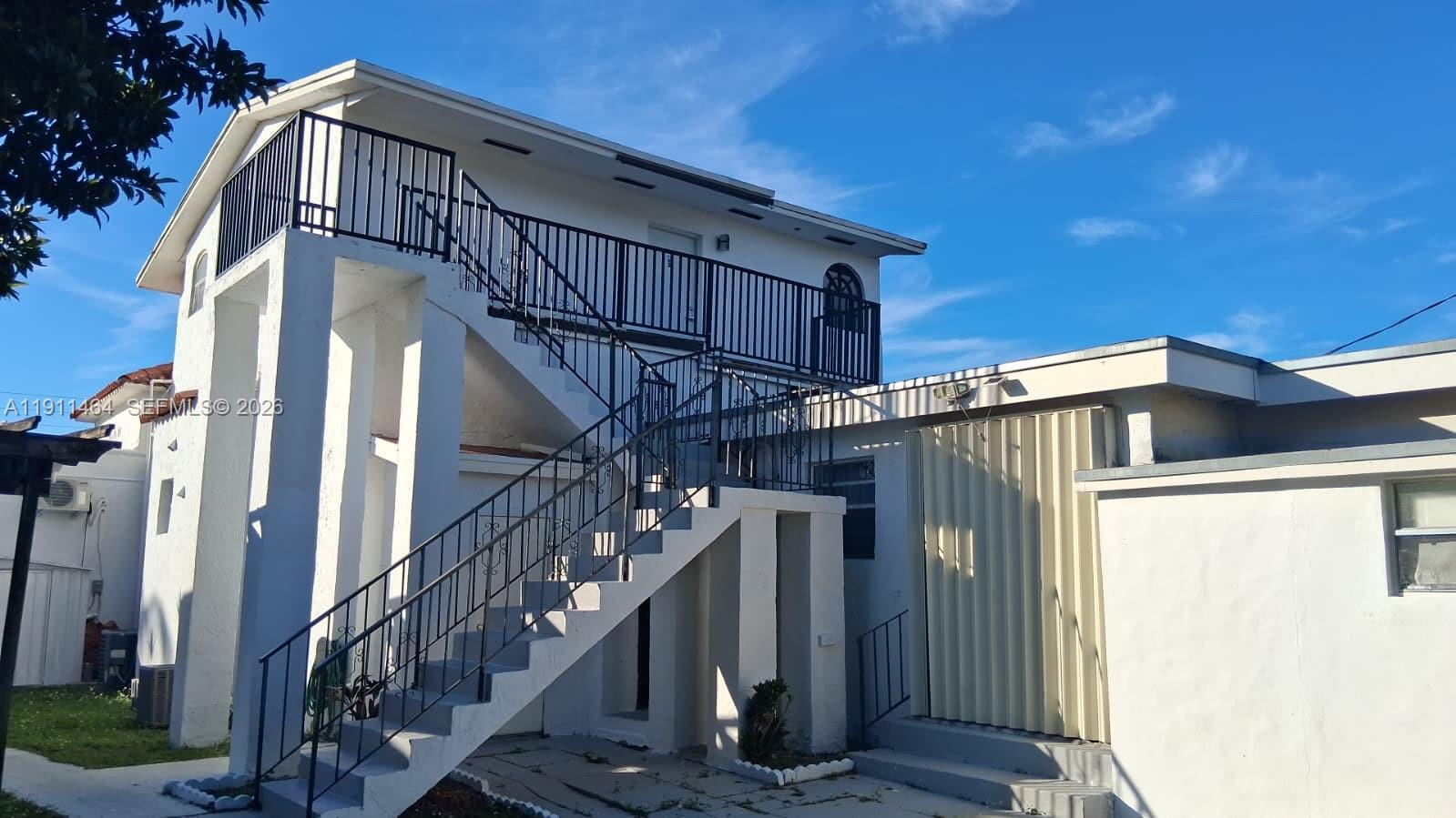 5629 Southwest 7th Street Miami, FL 33144 - Photo 22 of 25 a view of a house with wooden stairs