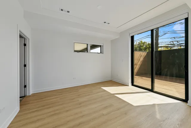 a view of an empty room with glass door