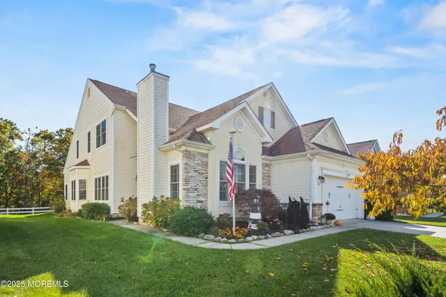 a view of a dining room with furniture a rug and wooden floor