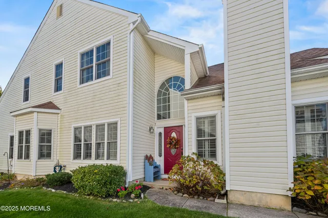 a view of a dining room with furniture a chandelier and wooden floor
