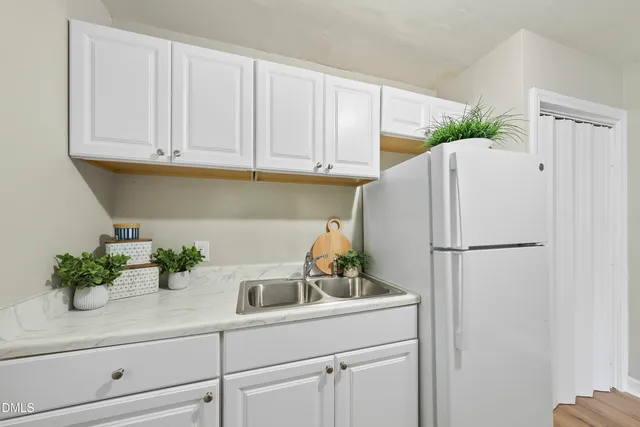 a white refrigerator freezer sitting in a kitchen